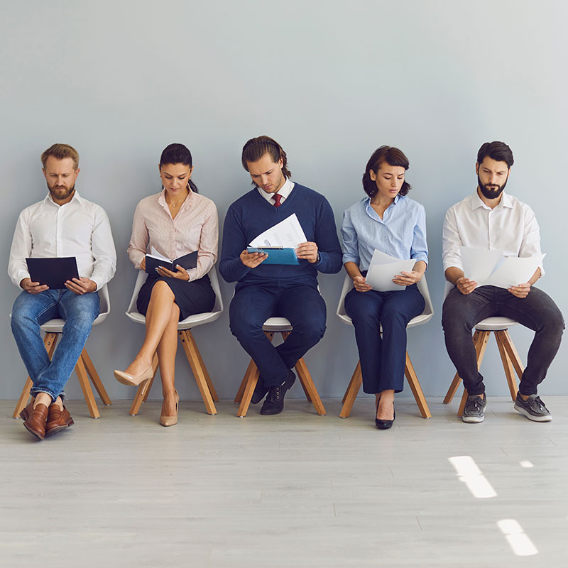 Candidate sitting in a waiting room reviewing application paperwork